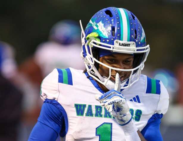 High school football game under stadium lights